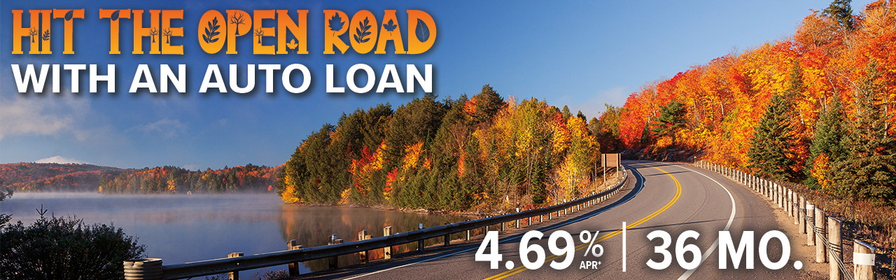 FallAuto-36MO-Webslider - Community West Credit Union Fall color-lined road beside a lake promoting an auto loan at 4.69% APR for a 36-month term.