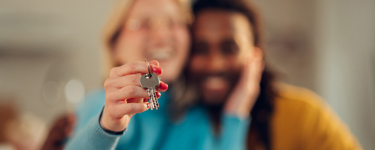 Couple holding pair of house keys