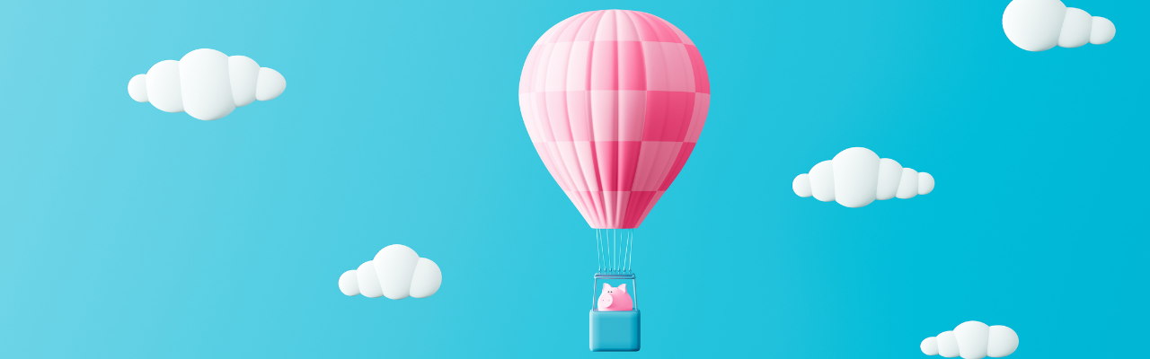 Piggy bank riding in a pink hot air balloon